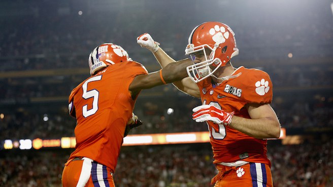 GLENDALE, AZ - JANUARY 11: Hunter Renfrow #13 of the Clemson Tigers celebrates with Germone Hopper #5 after scoring an 11 yard touchdown thrown by Deshaun Watson #4 in the first quarter against the Alabama Crimson Tide during the 2016 College Football Playoff National Championship Game at University of Phoenix Stadium on January 11, 2016 in Glendale, Arizona. (Photo by Christian Petersen/Getty Images)