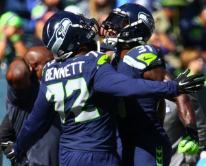 Seahawks defensive lineman Michael Bennett and Seahawks safety Kam Chancellor bump chests before the game against the Bears at CenturyLink Field Sunday, Sept. 27, 2015.